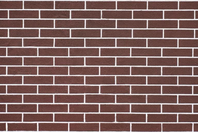 Brown brick wall with white grout lines pattern