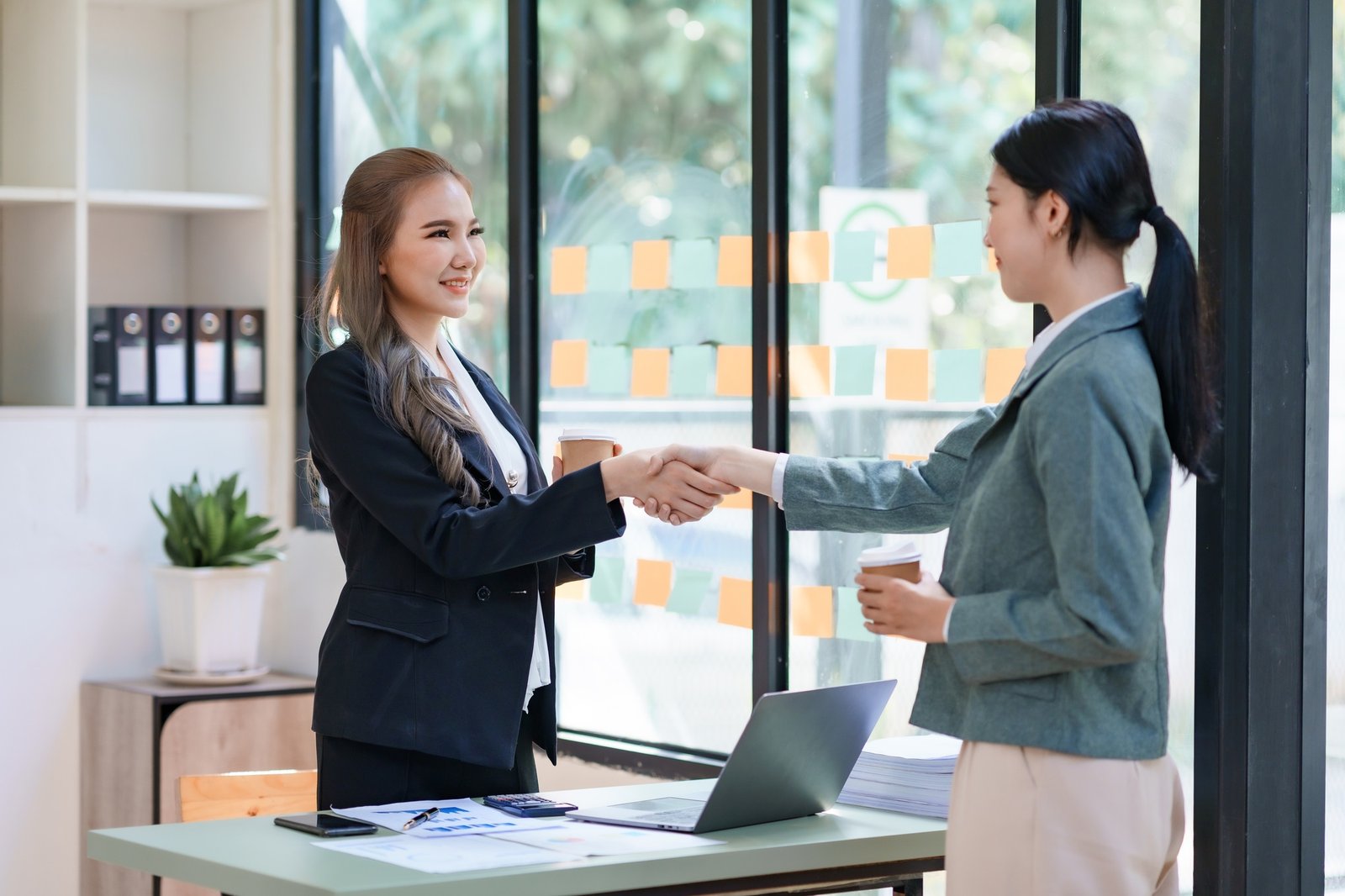 Asian Businesswoman shaking hands to confirm agreement in business