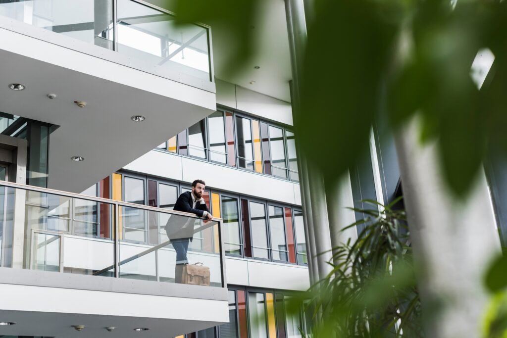 Businessman standing in office building, thinking