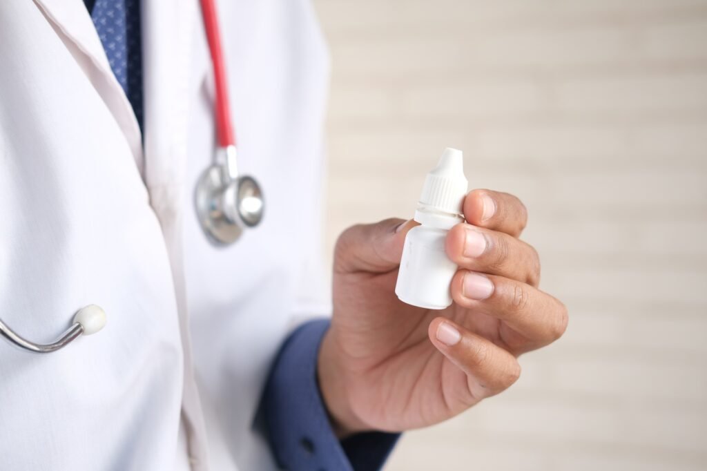 doctor hand hold eye drop bottle with copy space