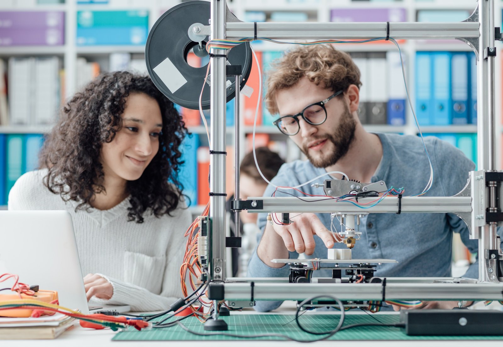 Engineers operating a 3D printer