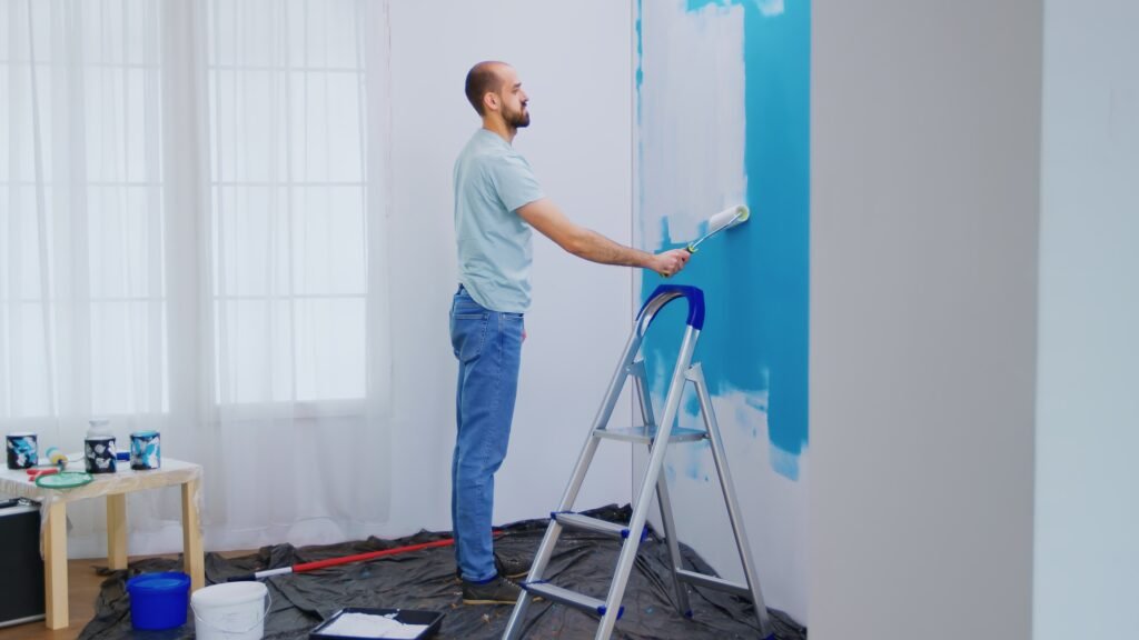 Handyman painting wall