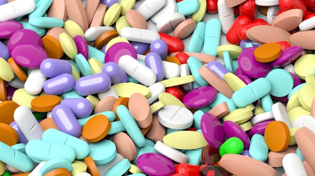 Pile of various colorful pills background.