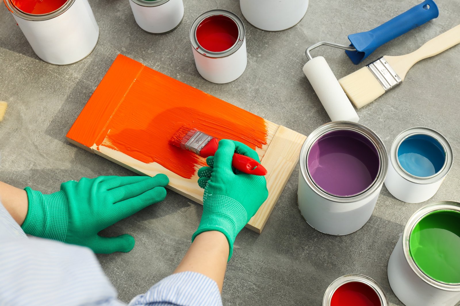 Brush applying a waterborne finish to a board